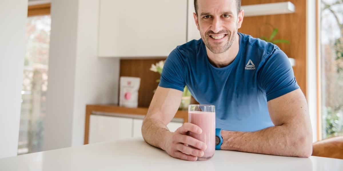 Smiley person drinking a Purition wholefood meal shake that's high in protein.