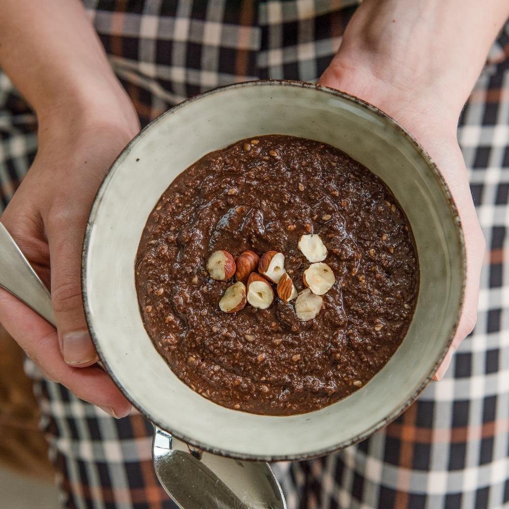 A bowl of instant oat free porridge made with Purition Chocolate & Hazelnut