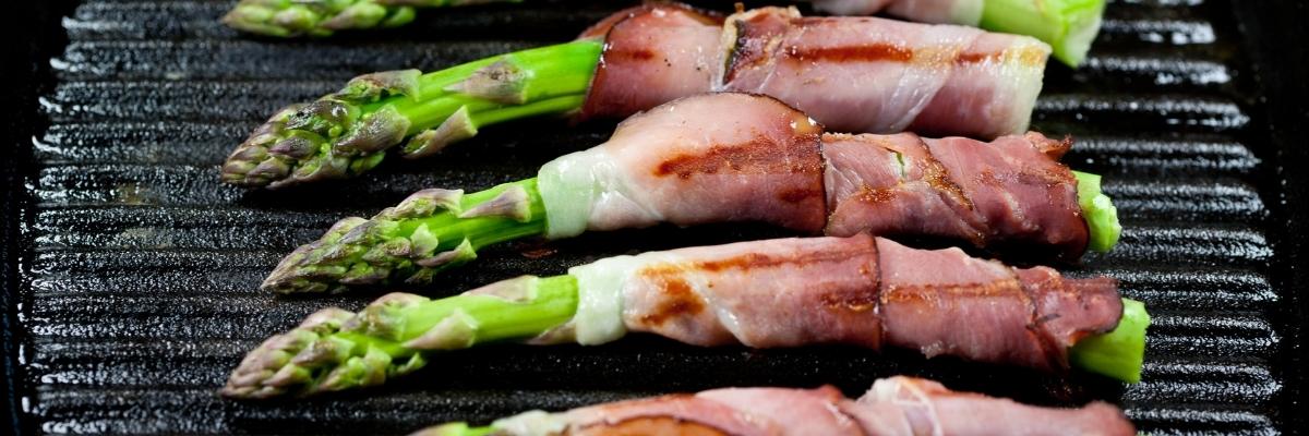 Asparagus rolled with parma ham and griddled.