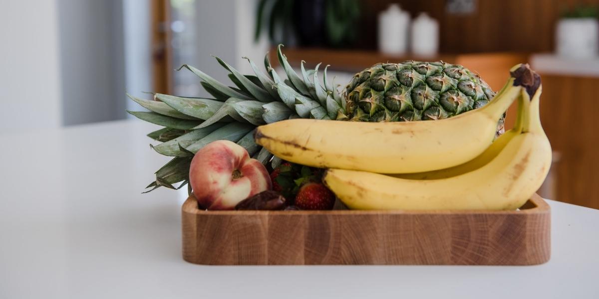 Fruit bowl; fresh pineapple, bananas, date, berries & peaches.