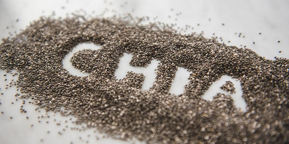 The word 'chia' written in a pile of chia seeds.