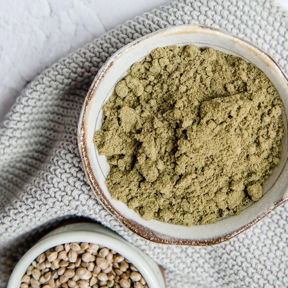 Bowl of hemp protein on grey tea towel