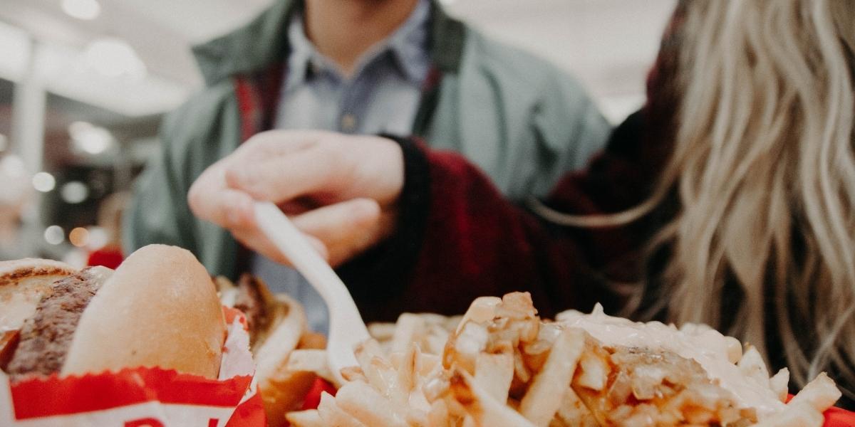 Woman eating chips with plastic fork