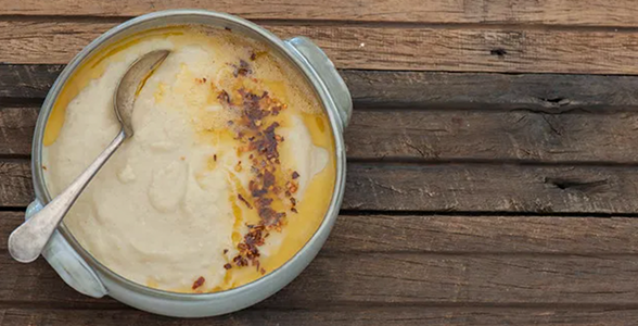 Cauliflower & yoghurt soup in bowl with spoon